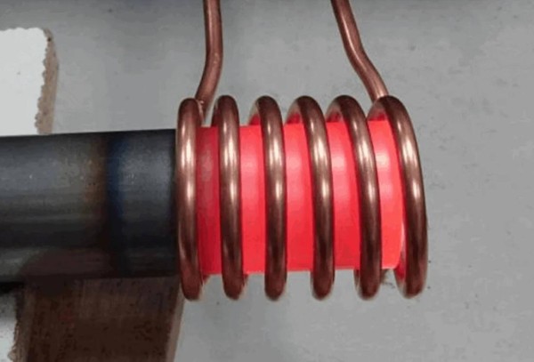 Induction post-heating of steel tubes